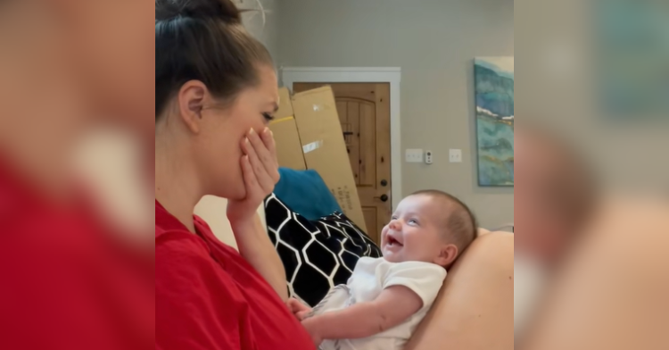 woman cries as baby laughs
