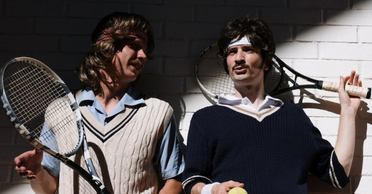 Men dressed as tennist from the 70s.