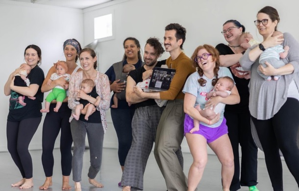 parents pose for a photo with their children at baby dance club