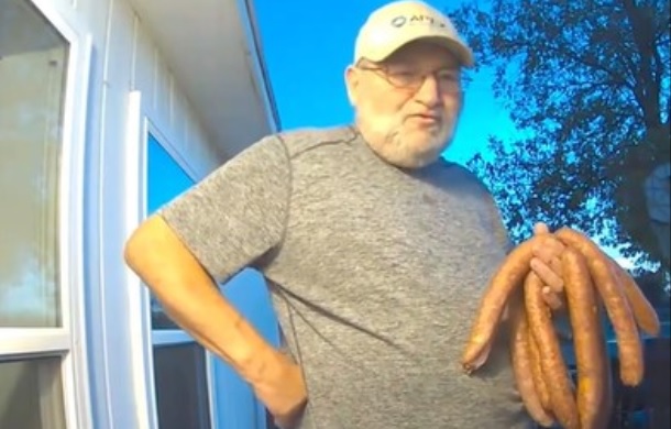 Image shows an older man bringing his neighbor homemade sausages.