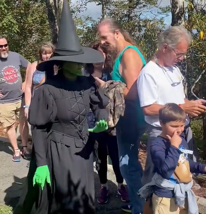 Elphaba moves aside a child