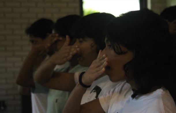 Image shows a row of people having a synchronized sneeze.