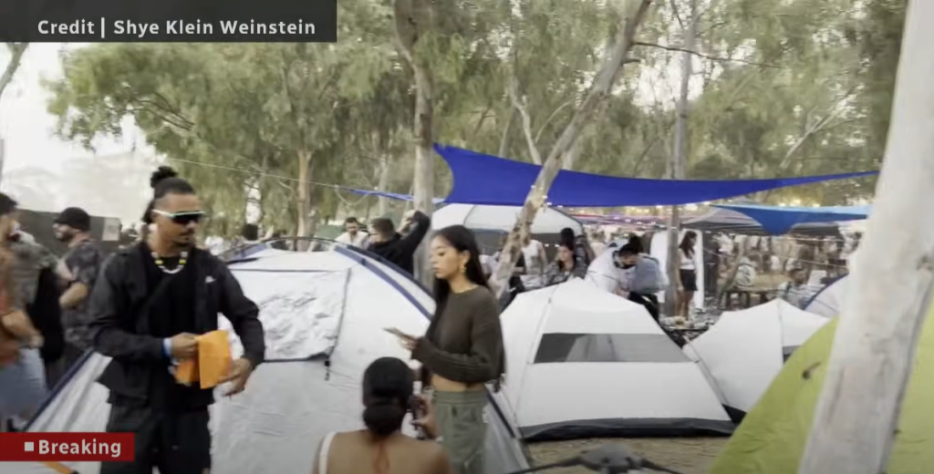 Groups of people gather around tents in Israel about three miles from the Gaza border.