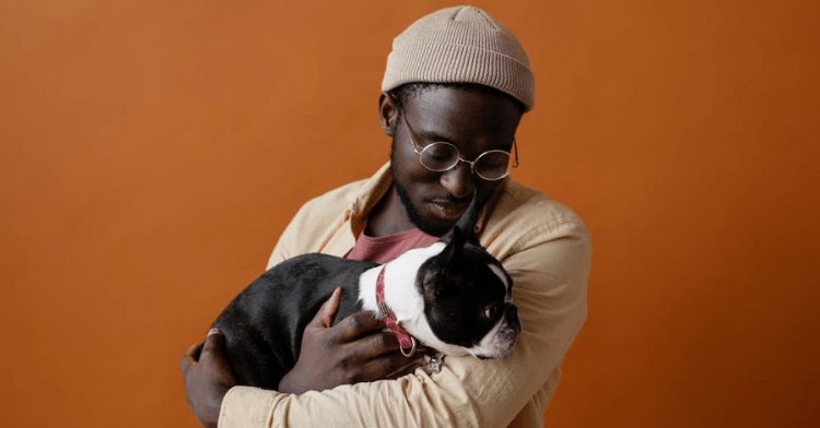 man holding dog in arms