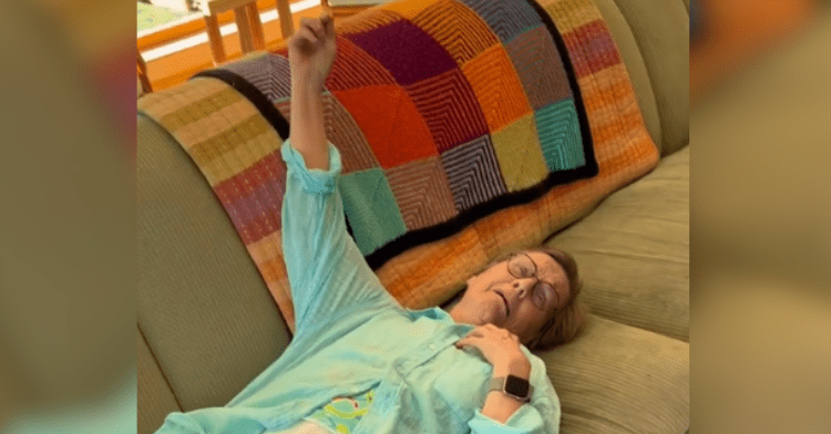 grandma laying on couch with arm up