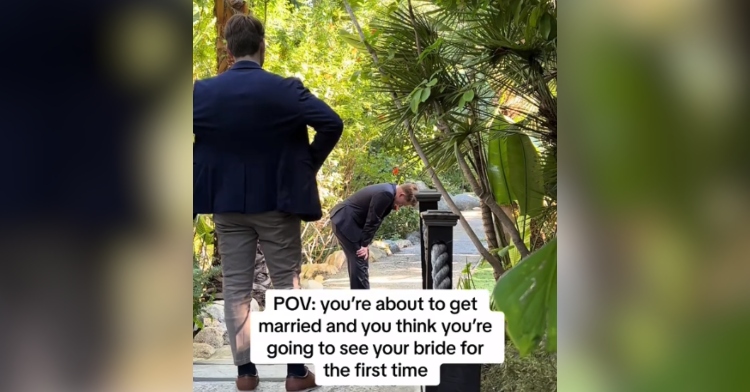 View of a man as he stands facing a groom a few feet away from him. The groom is bet over, hands on knees. Text on the image reads "POV: you're about to get married and think you're going to see your bride for the first time."