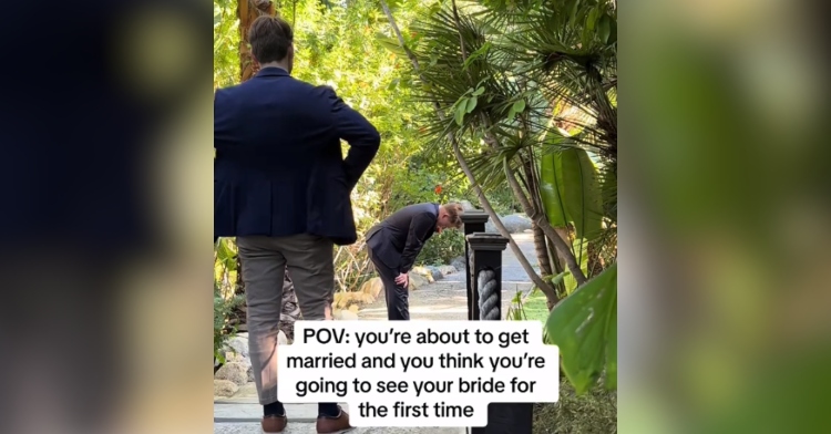 View of a man as he stands facing a groom a few feet away from him. The groom is bet over, hands on knees. Text on the image reads "POV: you're about to get married and think you're going to see your bride for the first time."