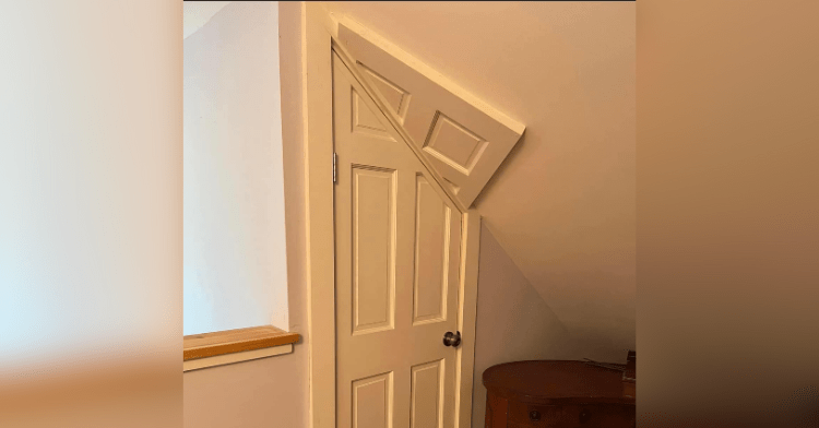 A door whose top right corner is at an angle because it the ceiling is too low