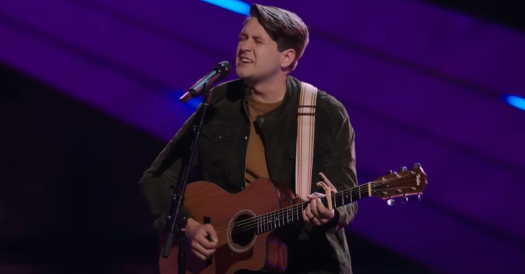 Lennon VanderDoes sings passionately into a mic as he plays the guitar on "The Voice," performing "The Night We Met" by Lord Huron.