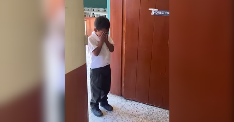 child stands crying by door