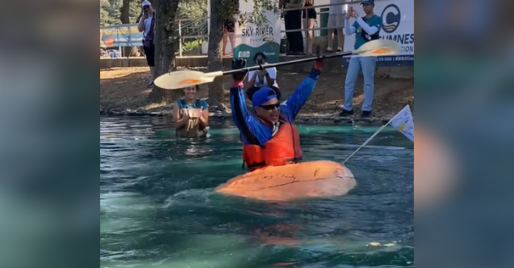 man in pumpkin boat