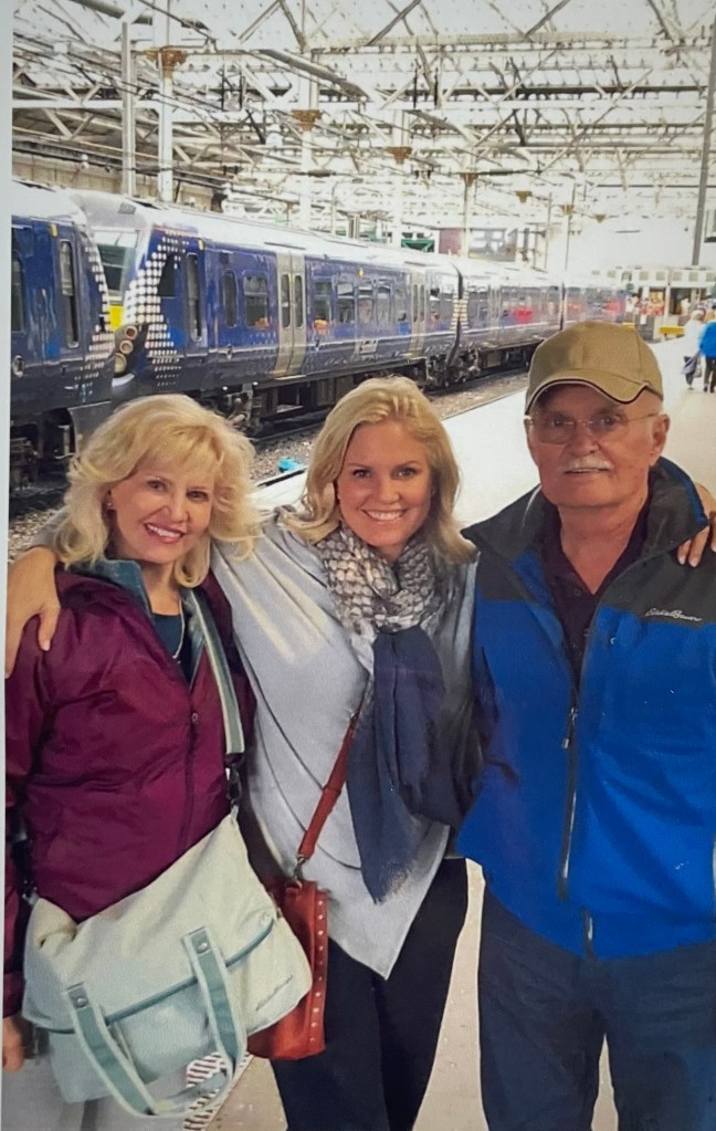 terri with her parents at a train station