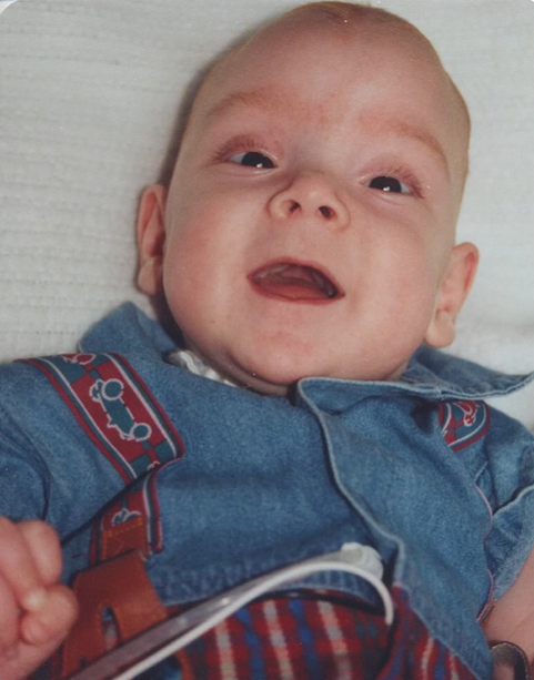 Baby Jacob smiles wide.