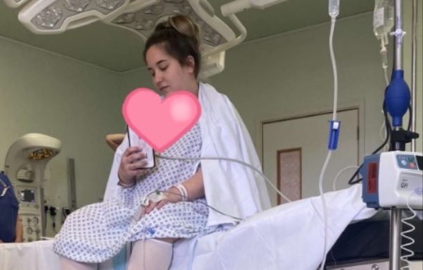 Woman on a hospital gurney having an epidural procedure before a C-section.