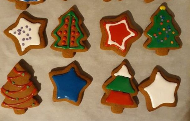Image shows decorated gingerbread cookies shaped in stars and trees.