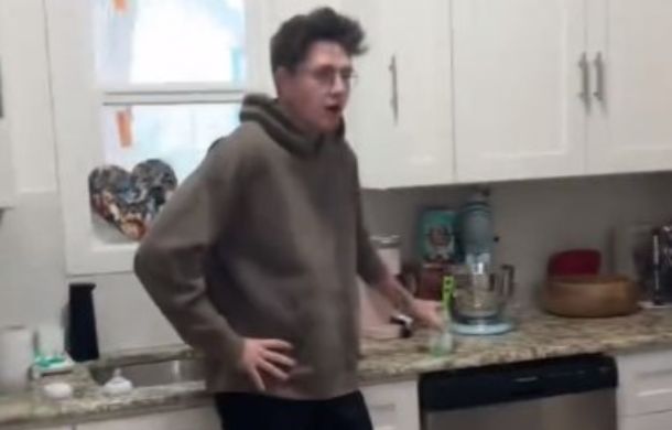 Man leaning a counter catching his breath after receiving a scare.