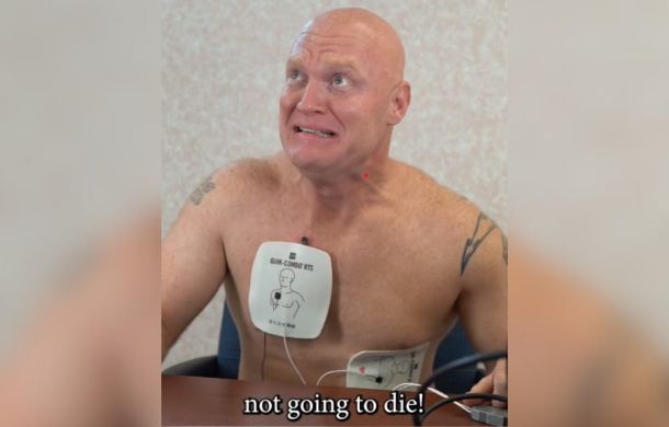 Image shows a scared patient (relax, he's an actor) with electrodes attached to his chest.