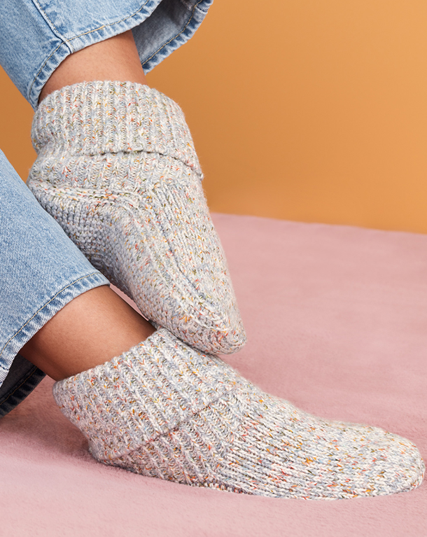 Image shows Bombas Gripper Slippers in Meteor (a cream color).