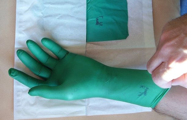 Green sterile surgical gloves.