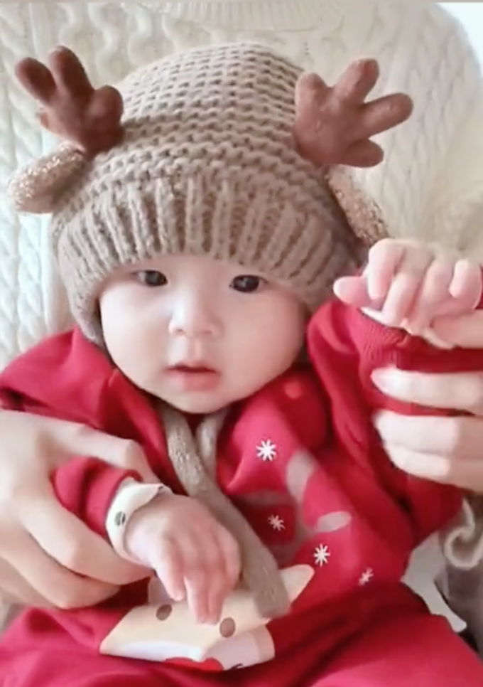 a baby dressed in a reindeer costume