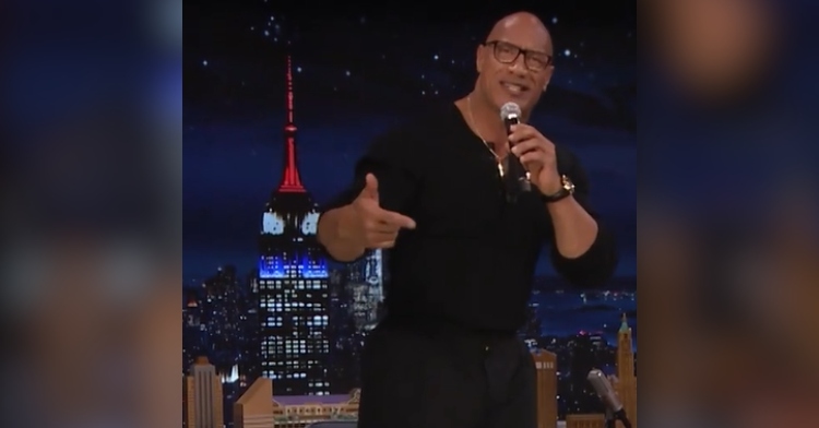 Dwayne "The Rock" Johnson stands in a confident pose as he sings into a mic on "The Tonight Show Starring Jimmy Fallon."