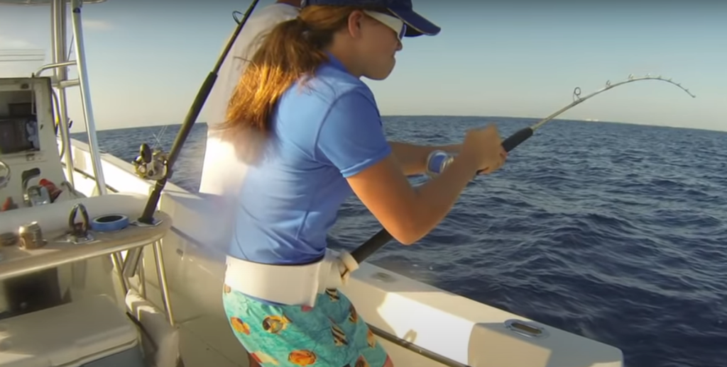 girl fishing off boat