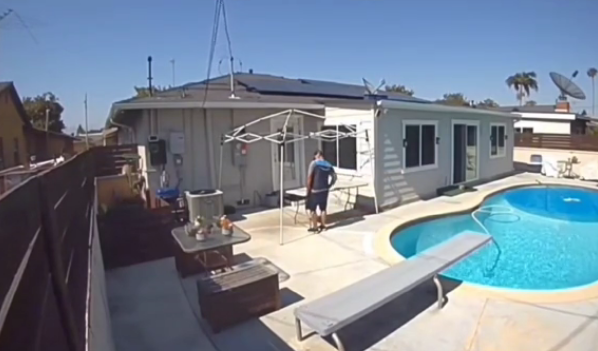delivery driver reads note from homeowner before diving into pool