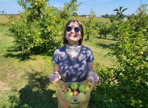 woman holding bag of apples