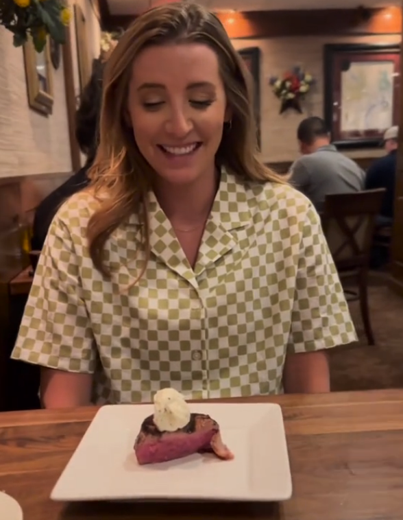 couple's Restaurant Gender Reveal with plate of steak