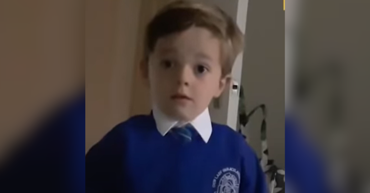 kid in blue sweater looks shocked