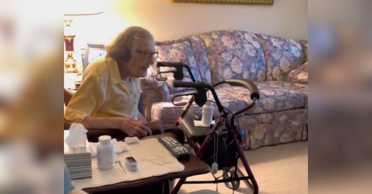 An elderly woman sits in her chair waiting for her surprise.