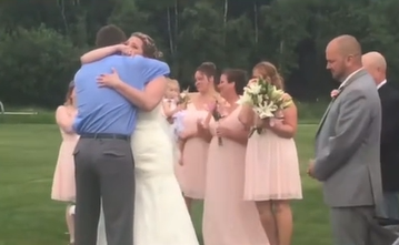 A bride hugs her son's organ donor recipient at her wedding. 