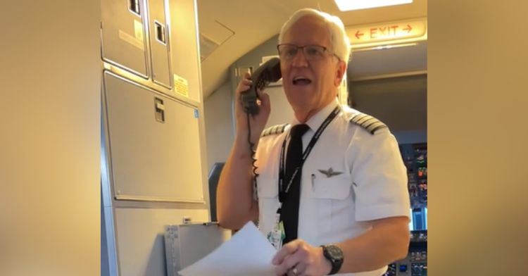 An airplane pilot delivers a speech to his passengers before takeoff.