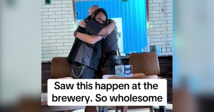 Two men at the bar sharing a sweet hug.