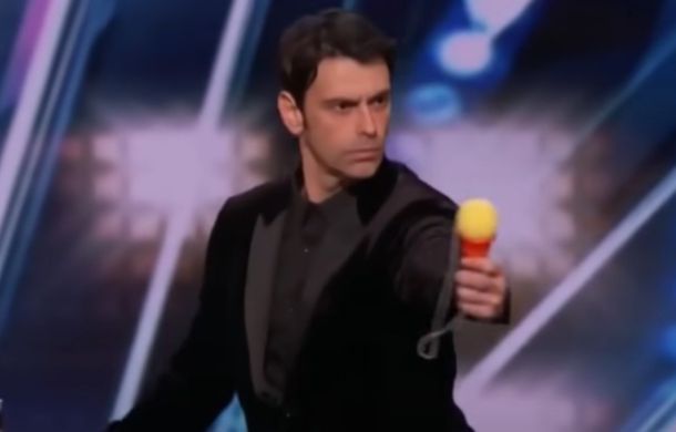 "Mentalist" preparing to wow the judges with his mentalist abilities. Man is shown holding a cone with a foam ball and string attached.