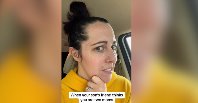 woman looks skeptical in yellow sweatshirt