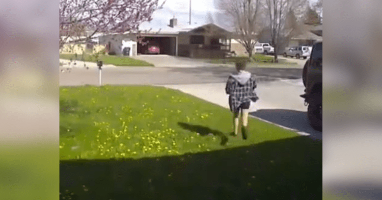 woman runs across street in neighborhood