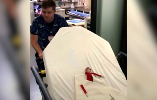Sam the elf being wheeled into surgery on a gurney.