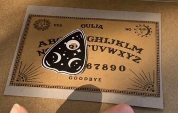 A mini Ouija board and planchette.