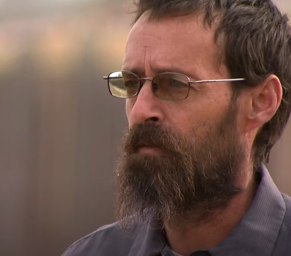 man looks pensively into the distance