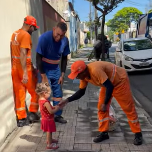 garbage collectors shake little girl's hand
