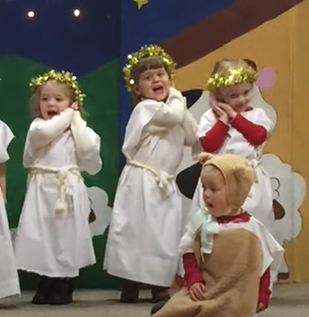 little kid angels with sleeping hands singing silent night
