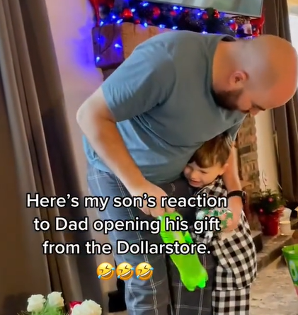 dad hugging son over mountain dew christmas present from dollar store