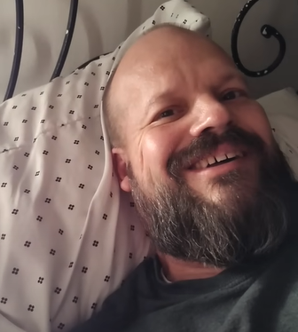 man in bed smiling