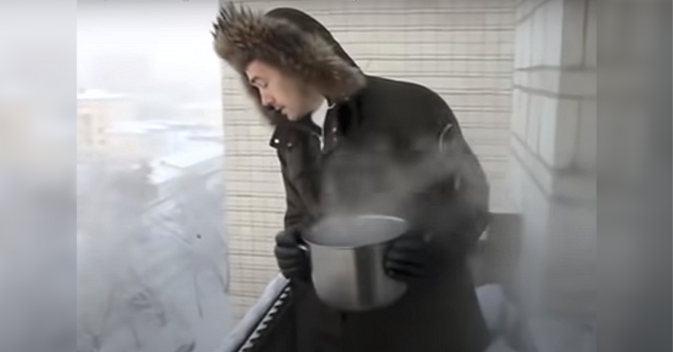 man prepares to throw boiling water in siberia