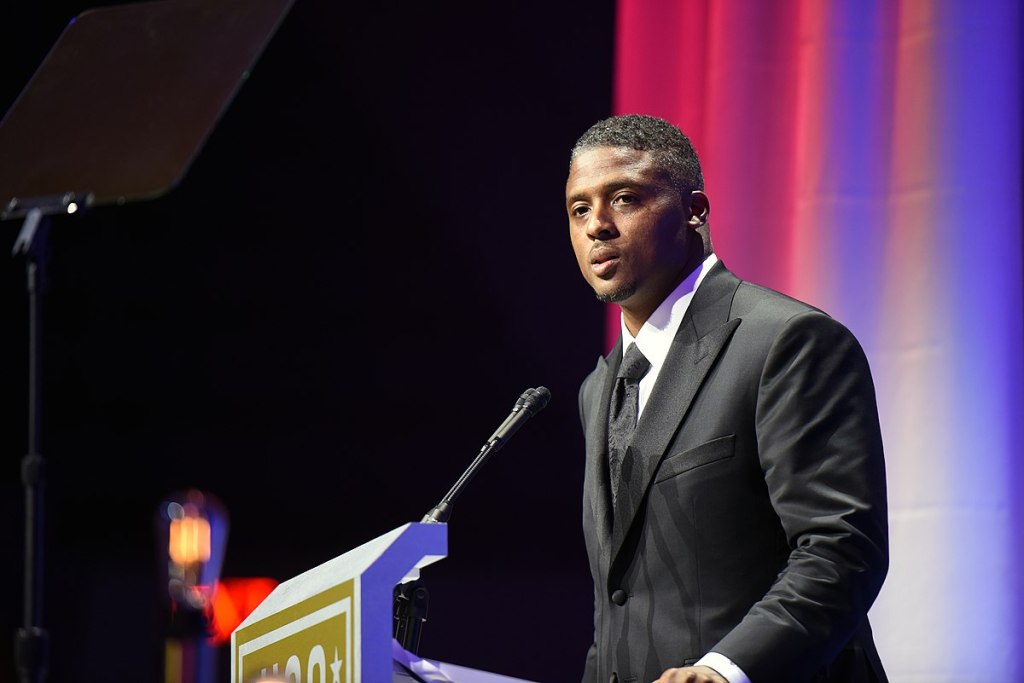 Former NFL star Warrick Dunn gives a public address.