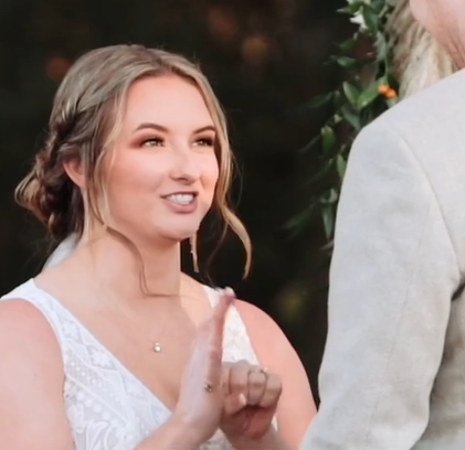A bride uses sign language to communicate her wedding vows.