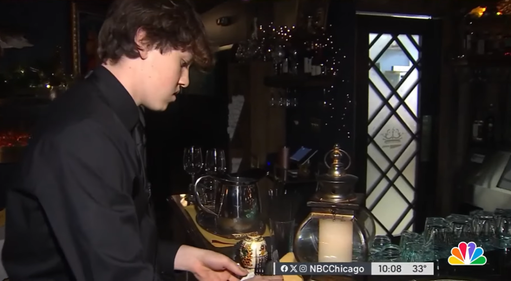 Teen busboy, Jackson, concentrates at a drink station at Carnivore and the Queen in Chicago.