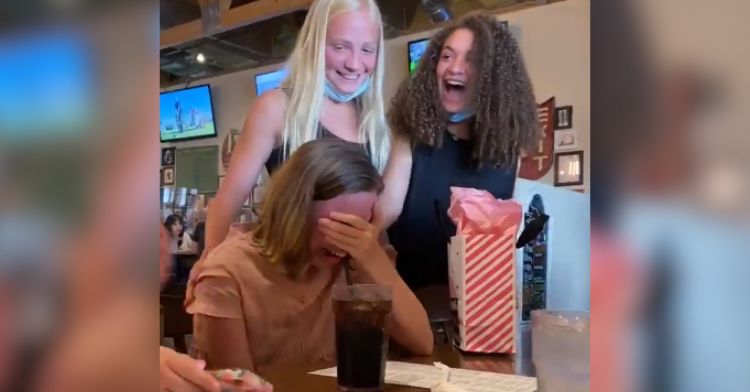 A girl bursts into happy tears when her friends from camp surprise her.