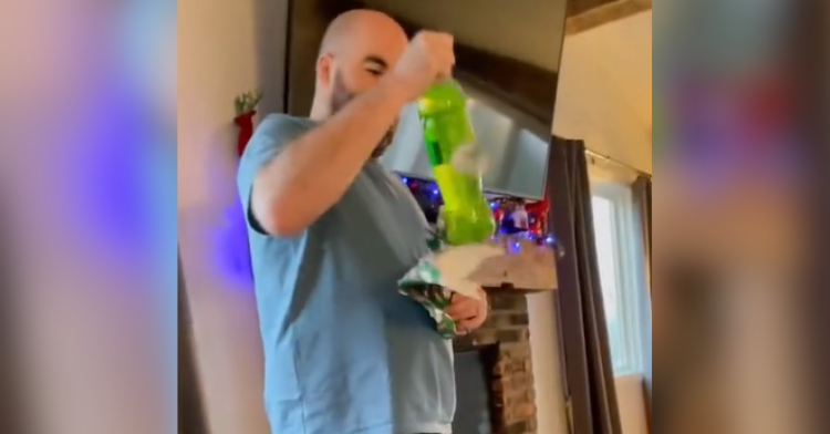 dad holds mountain dew christmas present